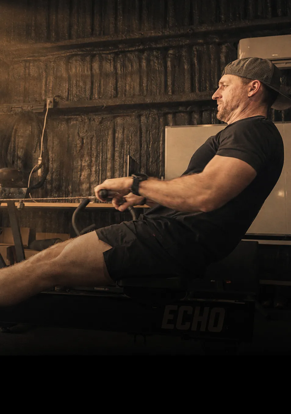 Athlete rowing in a garage gym